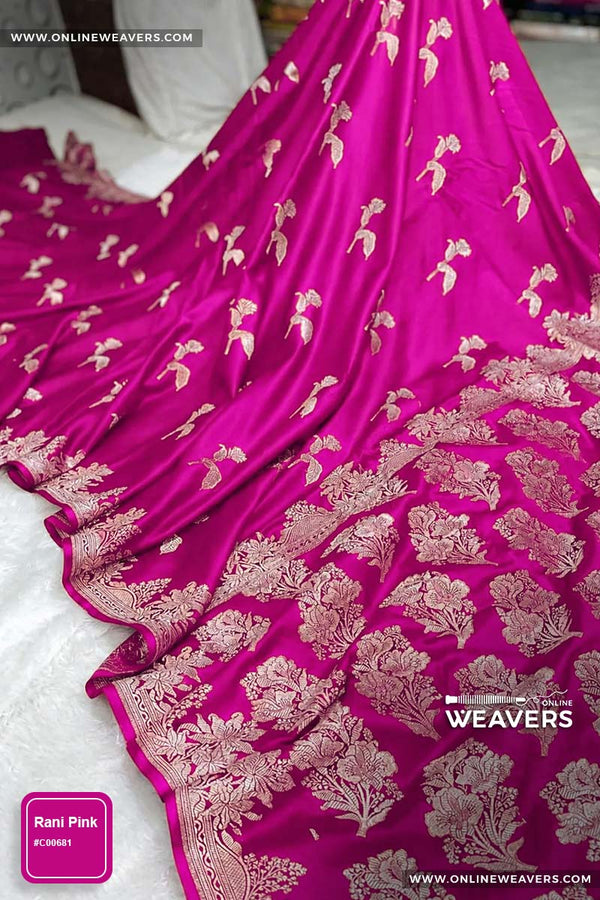 Rani Pink Banarasi silk saree with intricate gold zari rose floral woven work, draped elegantly to showcase its border and pattern. "OnlineWeavers' branding