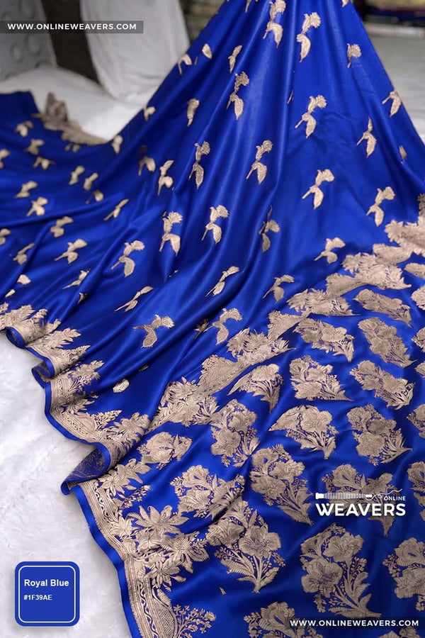 Royal Blue Banarasi silk saree with intricate gold zari rose floral woven work, draped elegantly to showcase its border and pattern. "OnlineWeavers' branding