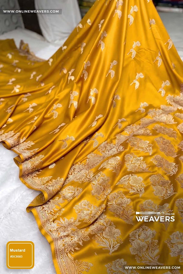 Mustard Yellow Banarasi silk saree with intricate gold zari rose floral woven work, draped elegantly to showcase its border and pattern. "OnlineWeavers' branding