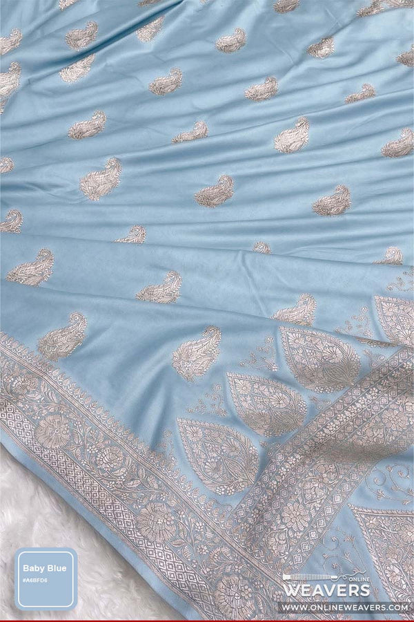 A light blue Banarasi Silk Saree, likely a saree, featuring silver metallic paisley. Mashru silk sheen