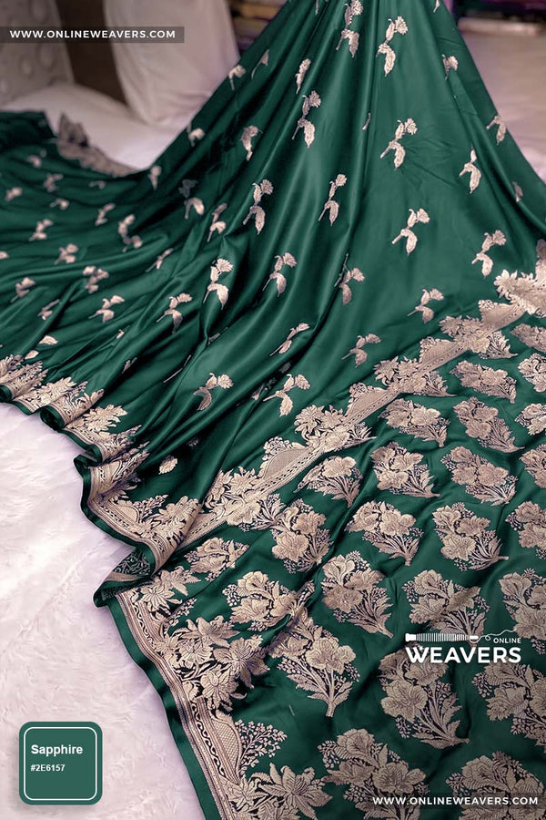 A dark green Banarasi silk saree with intricate gold zari rose floral woven work, draped elegantly to showcase its border and pattern. "OnlineWeavers' branding
