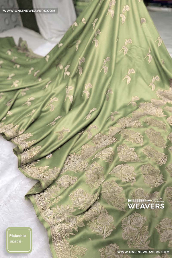 Pistachio green Banarasi silk saree with intricate gold zari rose floral woven work, draped elegantly to showcase its border and pattern. "OnlineWeavers' branding