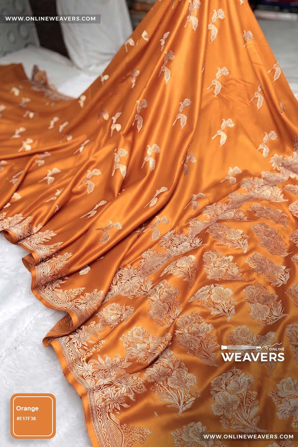 Orange Banarasi silk saree with intricate gold zari rose floral woven work, draped elegantly to showcase its border and pattern. "OnlineWeavers' branding