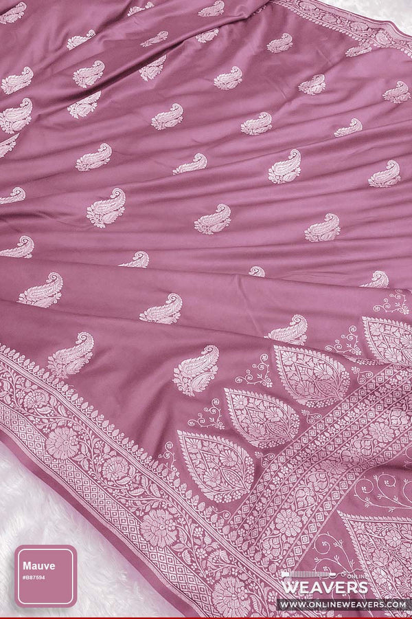 A mauve pink Banarasi silk saree with intricate zari woven paisley and floral motifs, "Online Weavers' branding, color swatch at lower corner