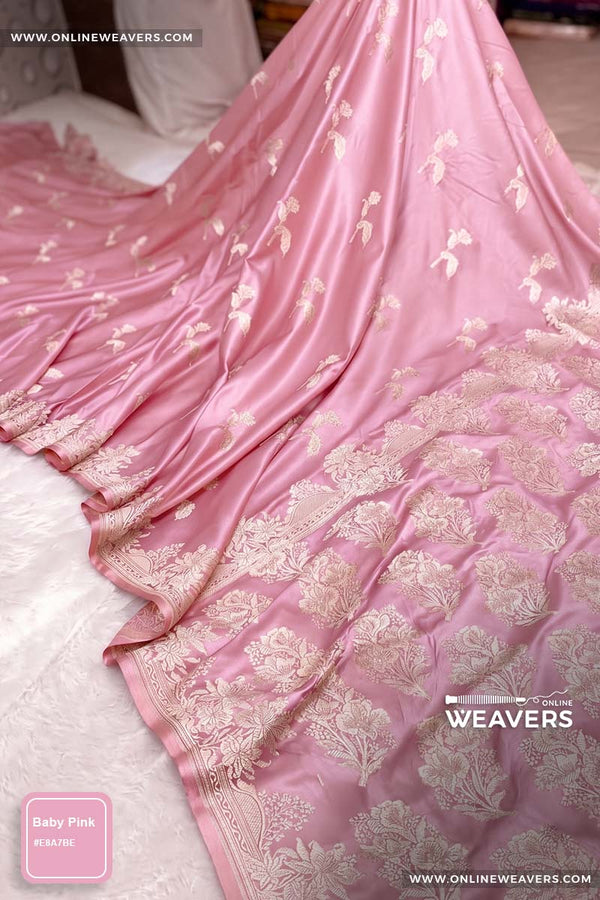 Baby Pink Banarasi silk saree with intricate gold zari rose floral woven work, draped elegantly to showcase its border and pattern. "OnlineWeavers' branding