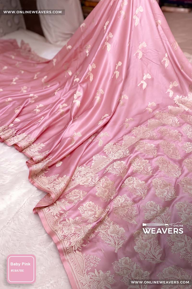 Baby Pink Banarasi silk saree with intricate gold zari rose floral woven work, draped elegantly to showcase its border and pattern. "OnlineWeavers' branding