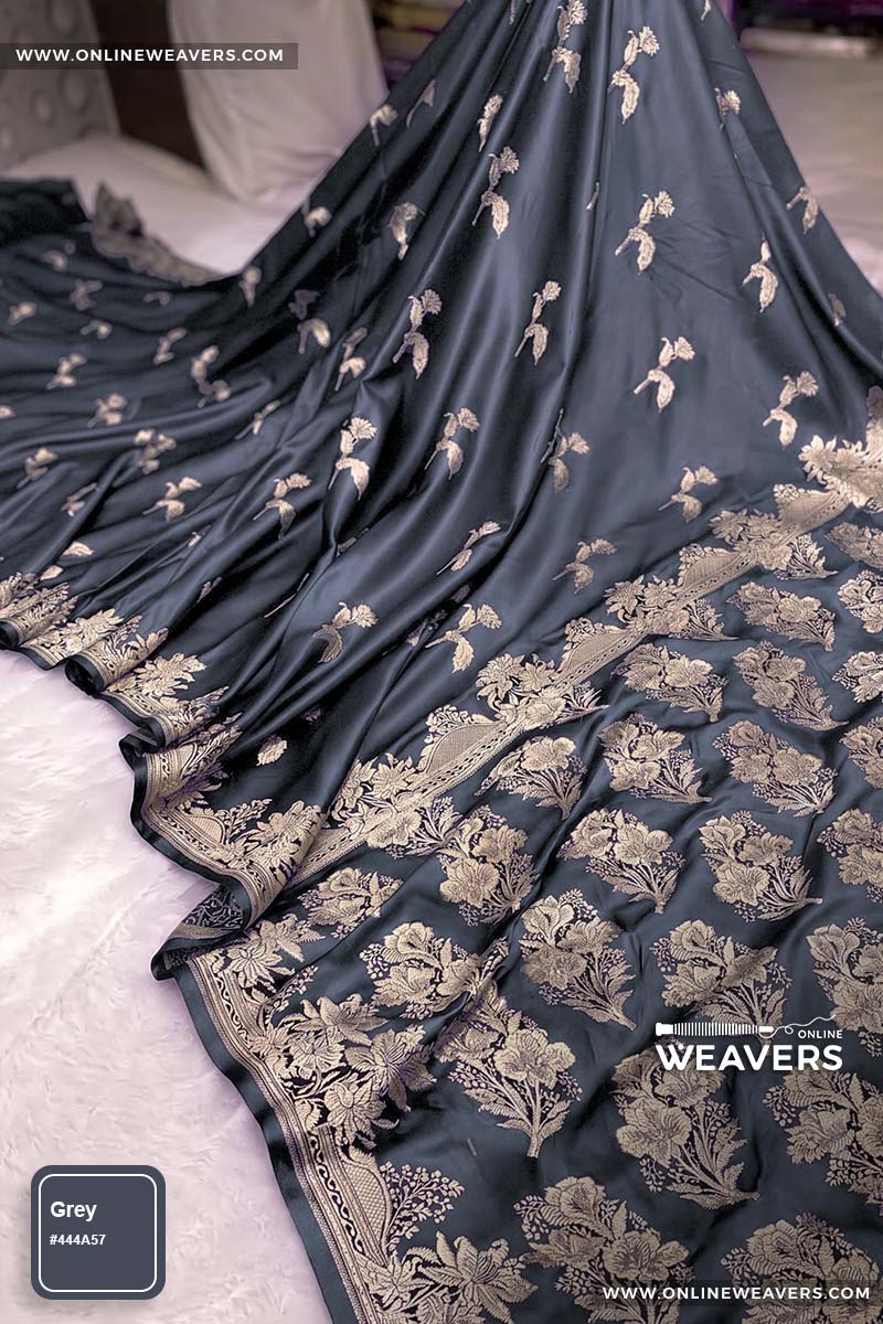 Grey Banarasi silk saree with intricate gold zari rose floral woven work, draped elegantly to showcase its border and pattern. "OnlineWeavers' branding