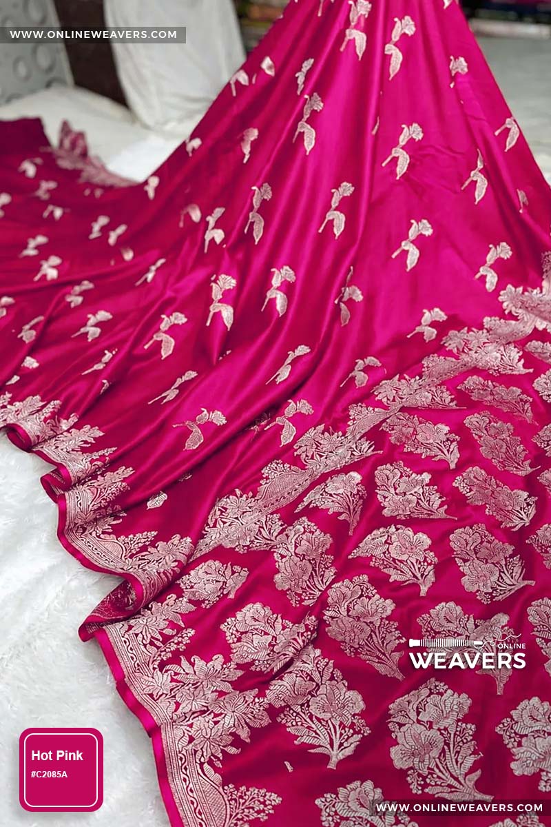 Hot pink Banarasi silk saree with intricate gold zari rose floral woven work, draped elegantly to showcase its border and pattern. "OnlineWeavers' branding