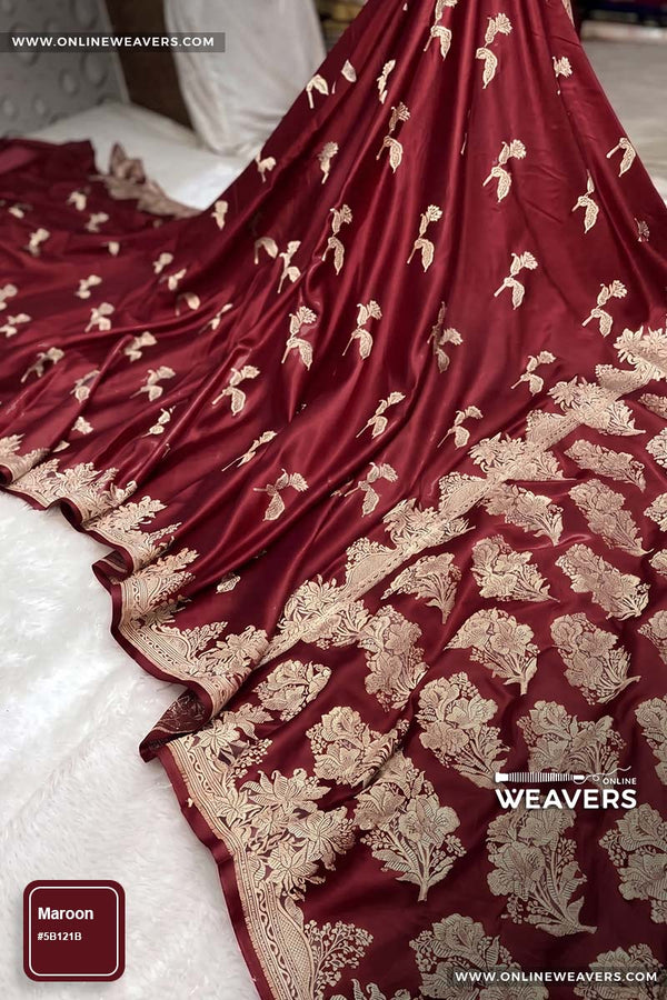 Maroon Red Banarasi silk saree with intricate gold zari rose floral woven work, draped elegantly to showcase its border and pattern. "OnlineWeavers' branding