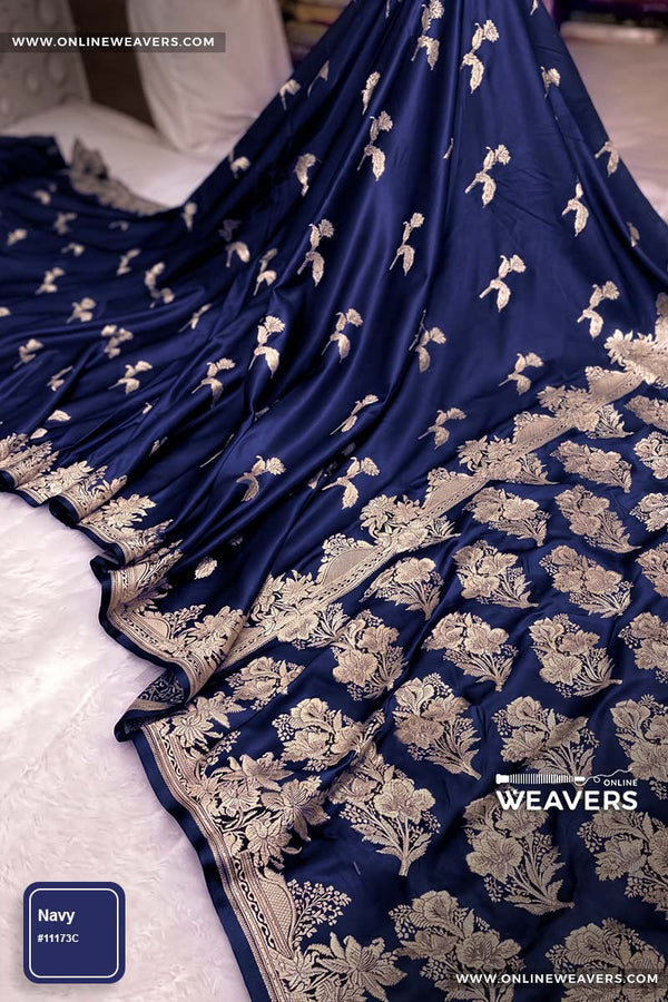 Navy Blue Banarasi silk saree with intricate gold zari rose floral woven work, draped elegantly to showcase its border and pattern. "OnlineWeavers' branding