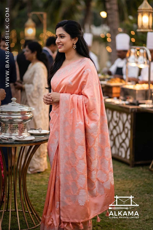 peach-orange Banarasi Mashru silk saree with 'Varanasi saree Manufacturer weaver' branding