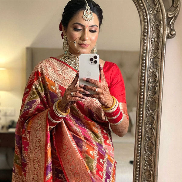 Woman in an authentic handloom-made Banarasi saree taking a mirror selfie