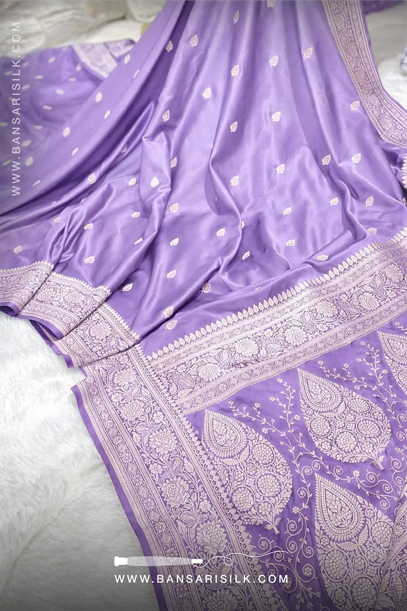 Lilac Purple saree with white patterns on a light gray background